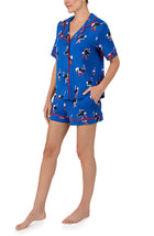 A lady wearing Aspen Knit Pj Set In Boots & Feathers print