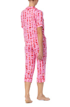 A lady wearing pink short sleeve teagan pj set with blushing cowgirl.