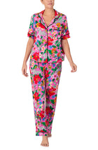 A lady wearing DAKOTA PJ SET IN CRITTER FLORAL