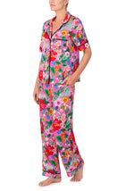 A lady wearing DAKOTA PJ SET IN CRITTER FLORAL