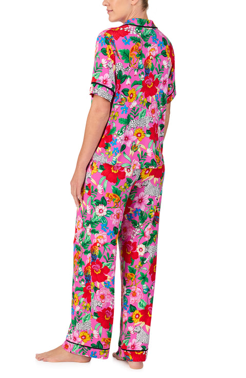 A lady wearing DAKOTA PJ SET IN CRITTER FLORAL