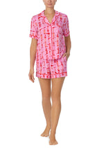 A lady wearing pink short sleeve teagan boxer set with blushing cowgirl print