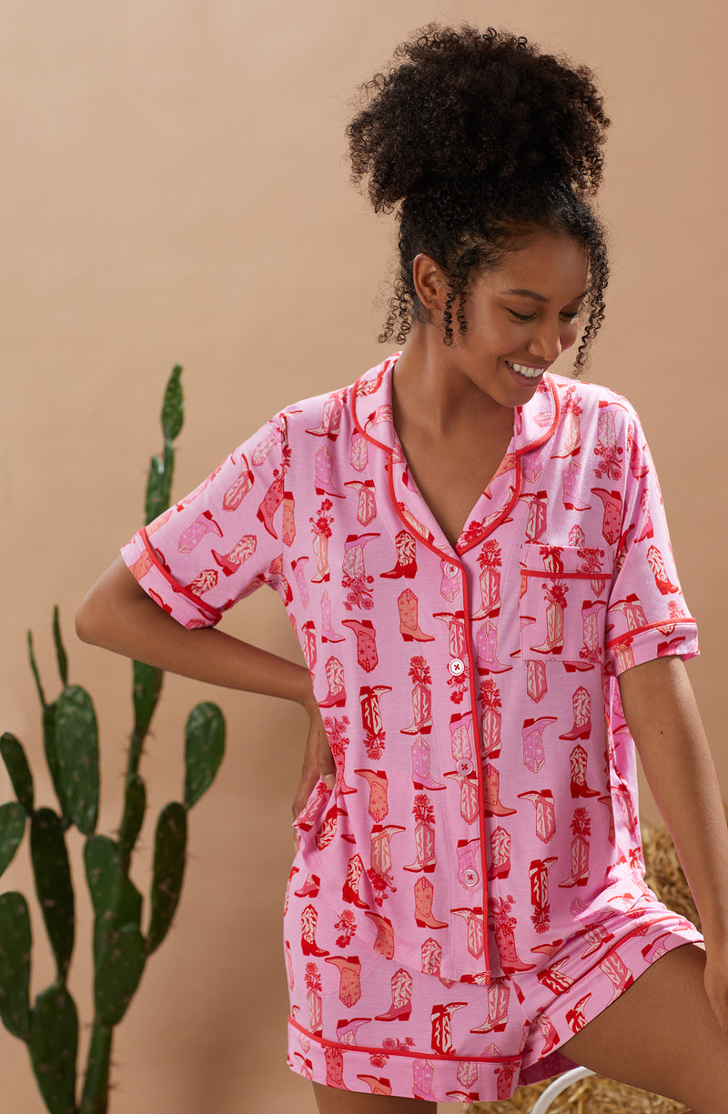 A lady wearing pink short sleeve teagan boxer set with blushing cowgirl print