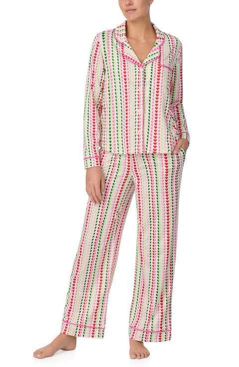 A lady wearing Charlotte Knit Pj Set In Merry Hearts print