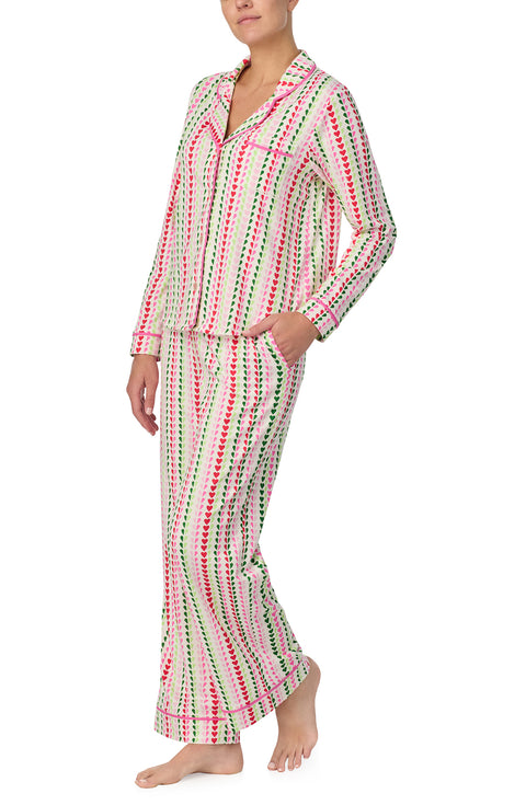 A lady wearing Charlotte Knit Pj Set In Merry Hearts print