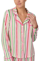 A lady wearing Charlotte Knit Pj Set In Merry Hearts print