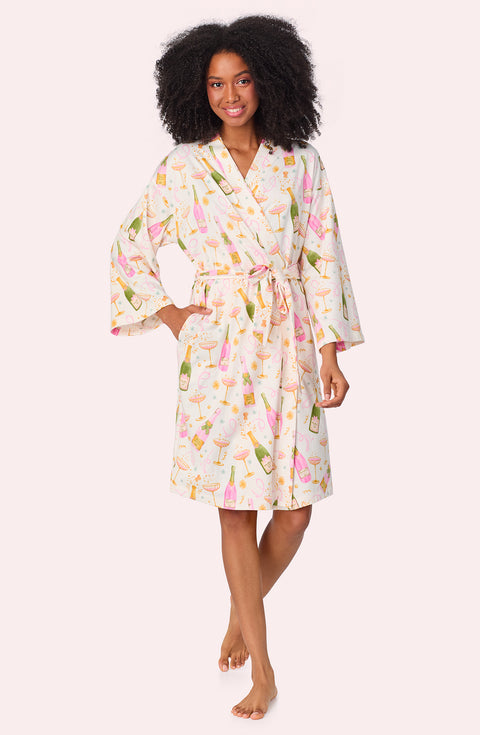 A lady wearing Nadia Knit Robe In Festive Fizz print