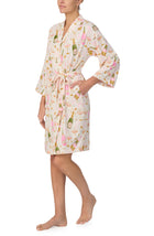 A lady wearing Nadia Knit Robe In Festive Fizz print