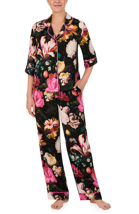 A lady wearing quarter sleeve Gramercy Woven Pj Set In Midnight Garden with black floral print.