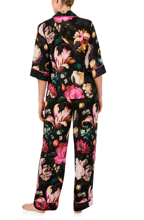 A lady wearing quarter sleeve Gramercy Woven Pj Set In Midnight Garden with black floral print.