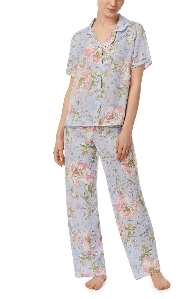 A lady wearing blue short sleeve madison pj set in blooming bride.