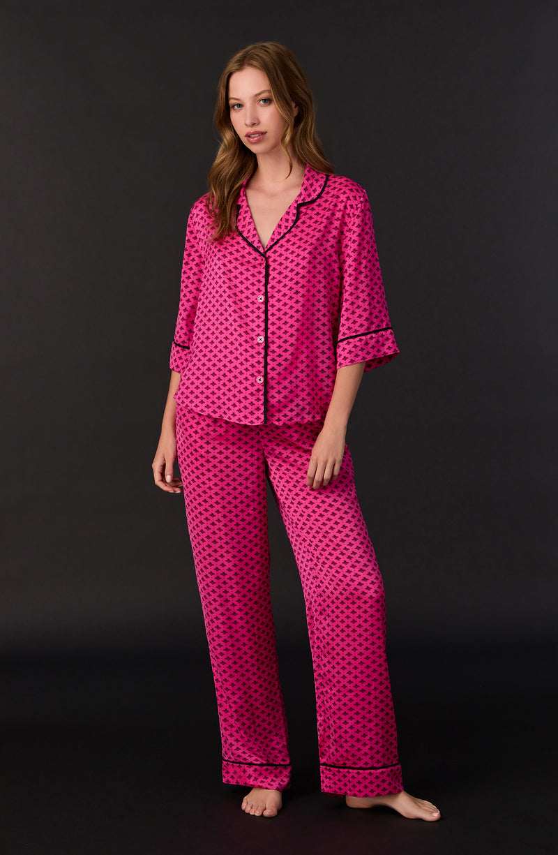 A lady wearing quarter sleeve Gramercy Woven Pj Set In Sweet Bee with bee geo print.