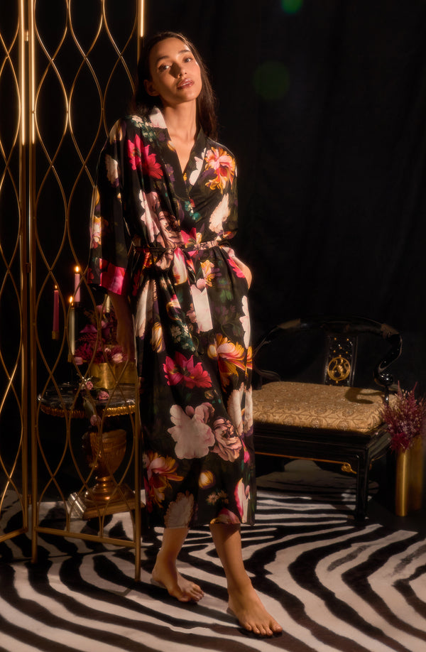 A lady wearing Lydia Woven Maxi Robe in Midnight Garden with black Floral print