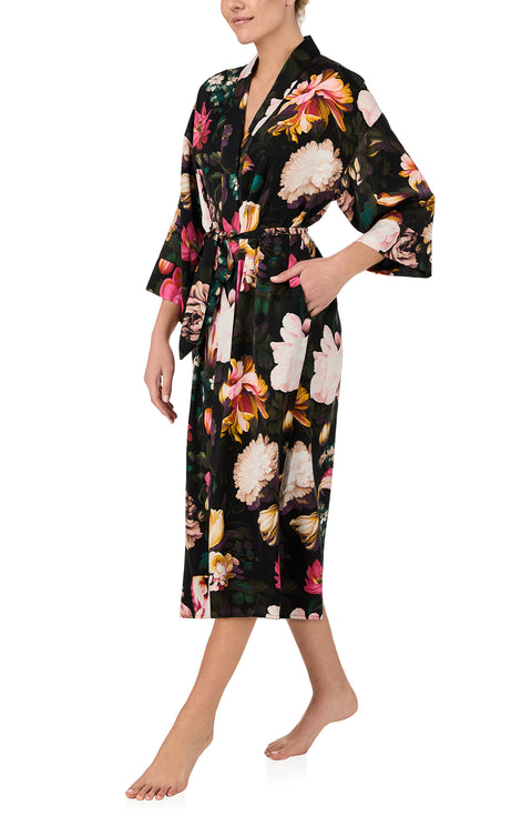 A lady wearing Lydia Woven Maxi Robe in Midnight Garden with black Floral print