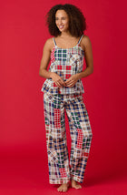 A lady wearing a sleeveless natalie pj set with country plaid print.