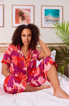 A lady wearing multi color short sleeve chelsa crop pj set with summer orchid.