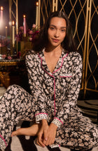 A lady wearing long sleeve Charlotte Knit Pj Set In Daisy Delight with black daisies print