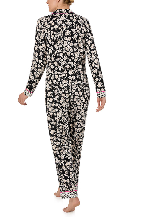 A lady wearing long sleeve Charlotte Knit Pj Set In Daisy Delight with black daisies print