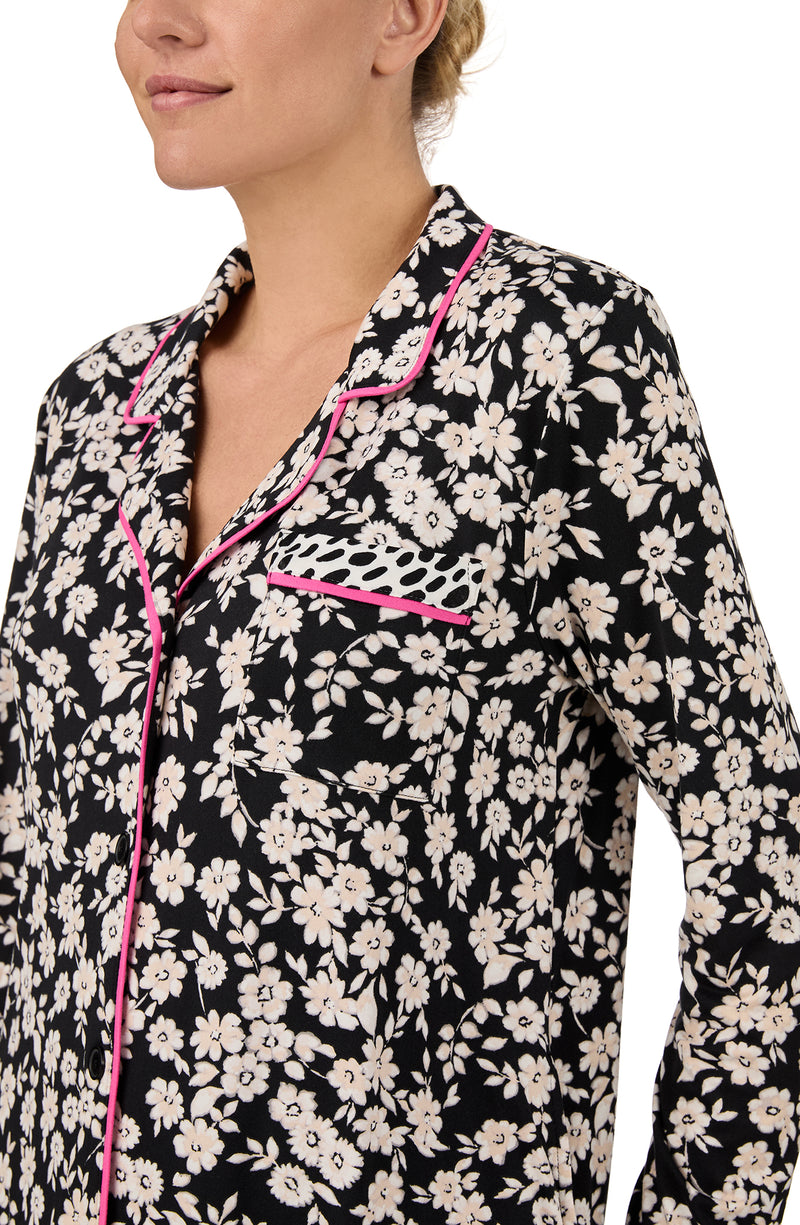 A lady wearing long sleeve Kylie Knit Sleepshirt In Daisy Delight with Black daisies print.