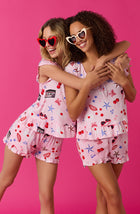 A lady wearing pink short sleeve Phoebe Pj Set with Miss Americana print