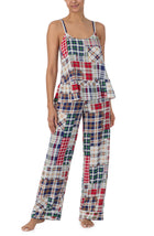 A lady wearing a sleeveless natalie pj set with country plaid print.