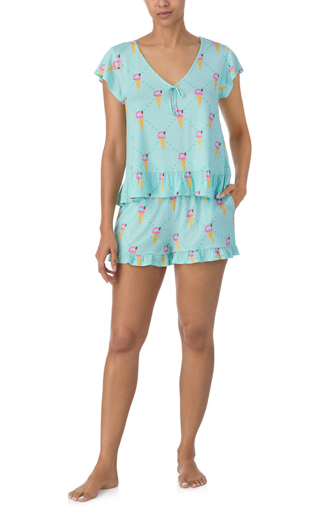 A lady wearing light blue short sleeve Phoebe Pj Set with Minty Sweets print