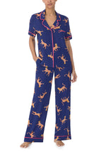 A lady wearing blue short sleeve victoria long pj set  with royal leopard.