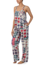 A lady wearing a sleeveless natalie pj set with country plaid print.