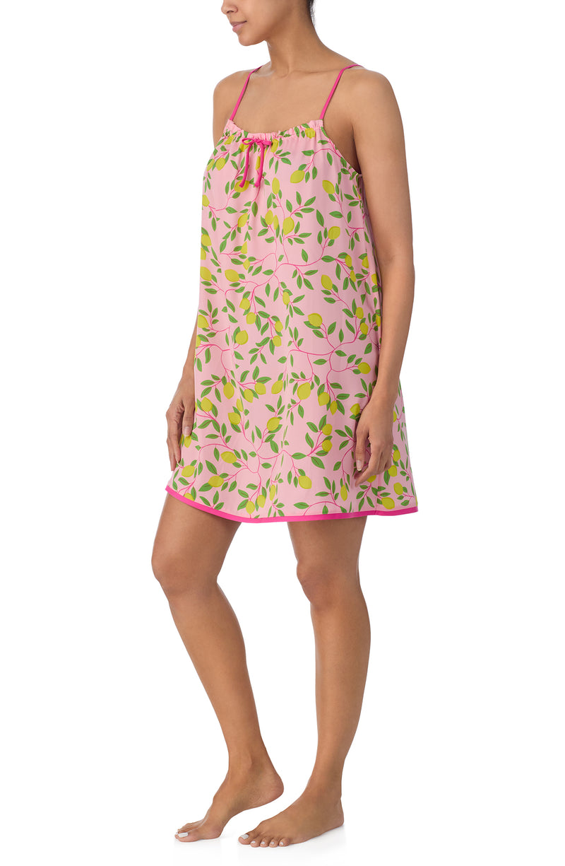 A lady wearing pink sleeveless izzy chemise with pink lemonade print.