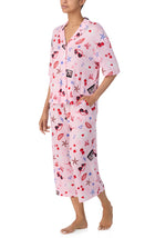 A lady wearing pink short sleeve kiara pj set with miss americana print.