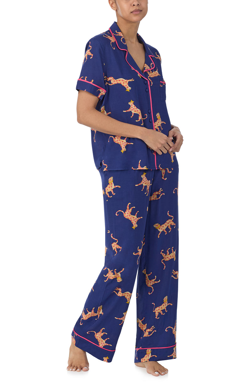 A lady wearing blue short sleeve victoria long pj set  with royal leopard.