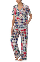 A lady wearing multi color victoria long pj set with country plaid print.