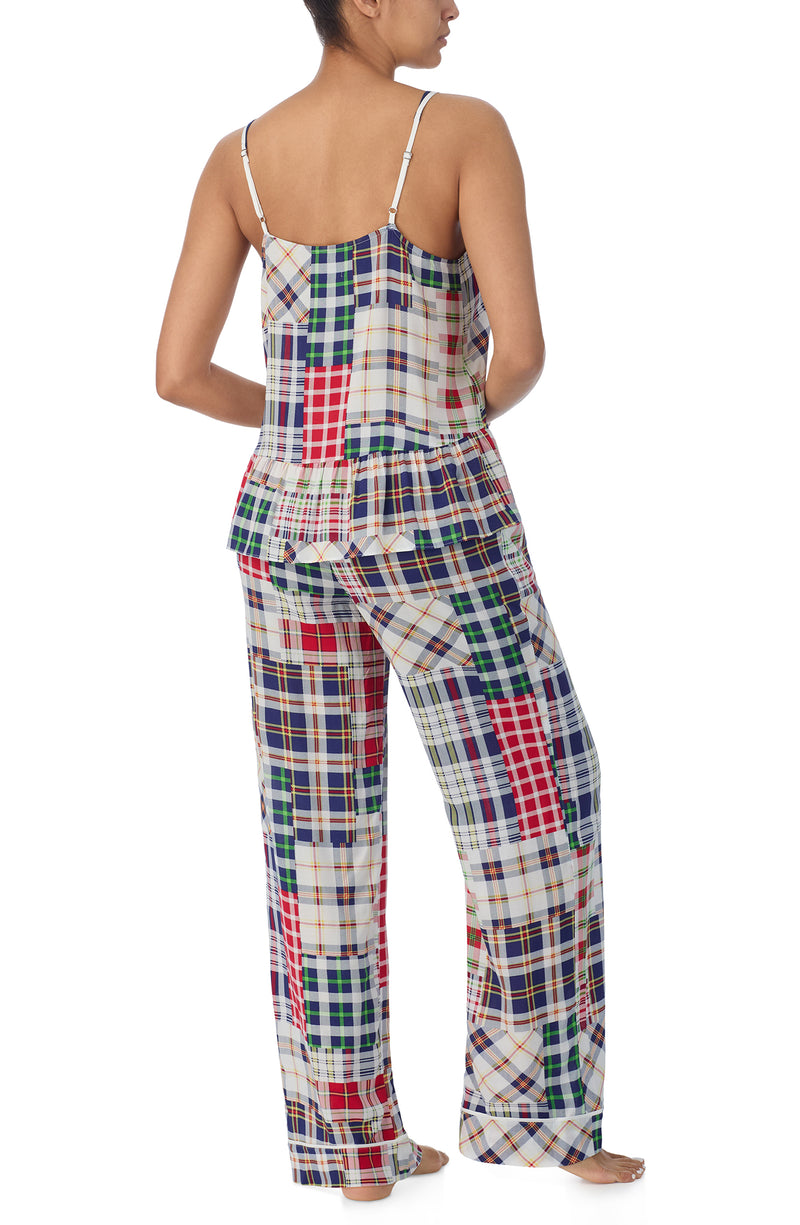 A lady wearing a sleeveless natalie pj set with country plaid print.