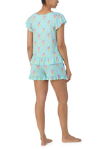 A lady wearing light blue short sleeve Phoebe Pj Set with Minty Sweets print