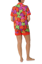 A lady wearing multi color short sleeve chelsea short pj set with electric floral pj set.