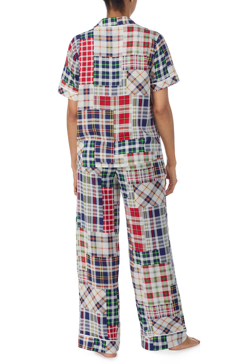 A lady wearing multi color victoria long pj set with country plaid print.