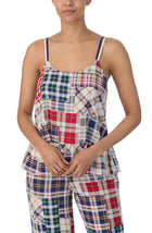 A lady wearing a sleeveless natalie pj set with country plaid print.