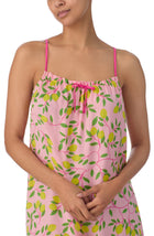 A lady wearing pink sleeveless izzy chemise with pink lemonade print.